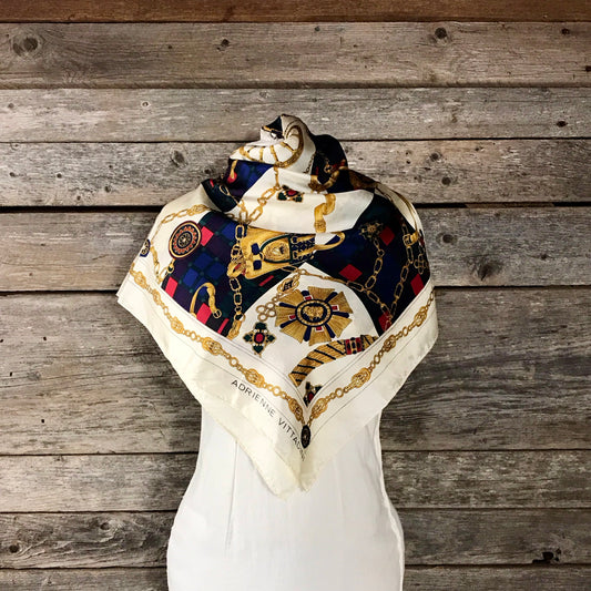 Adrienne Vittadini Silk Scarf in Red, Blue and Gold on Cream Background, Print of Chains, Medals and Saddlebags Design. Square 33 inches.